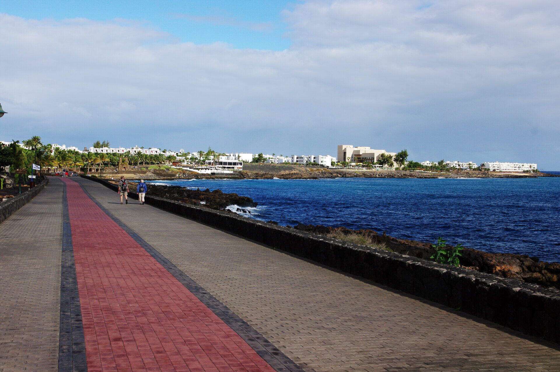 Costa Teguise beach with turquoise water and volcanic landscape behind