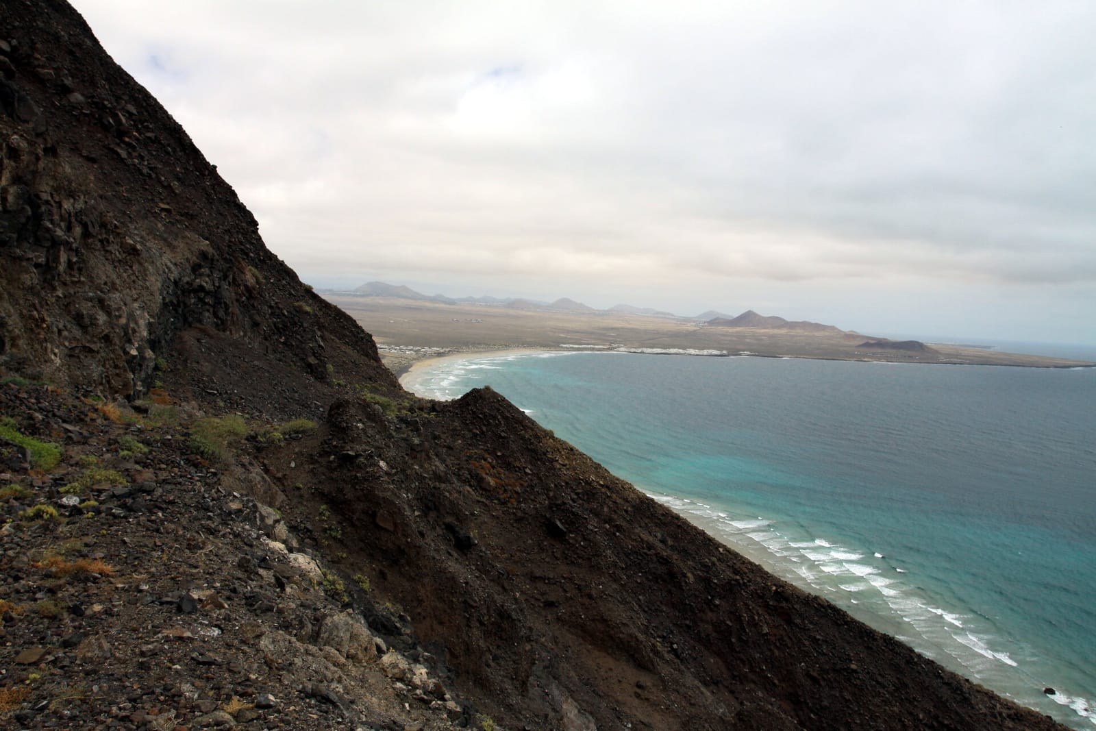 Trail runners on the Famara cliffs in Lanzarote