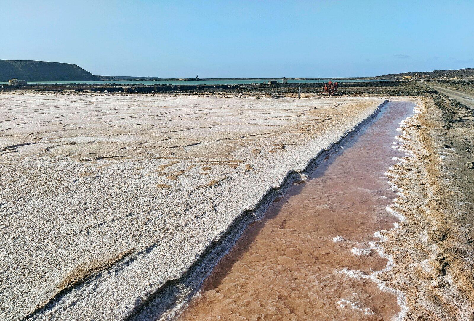 Salinas de Janubio salt flats on the southwest coast of Lanzarote, with pink water and white salt mountains