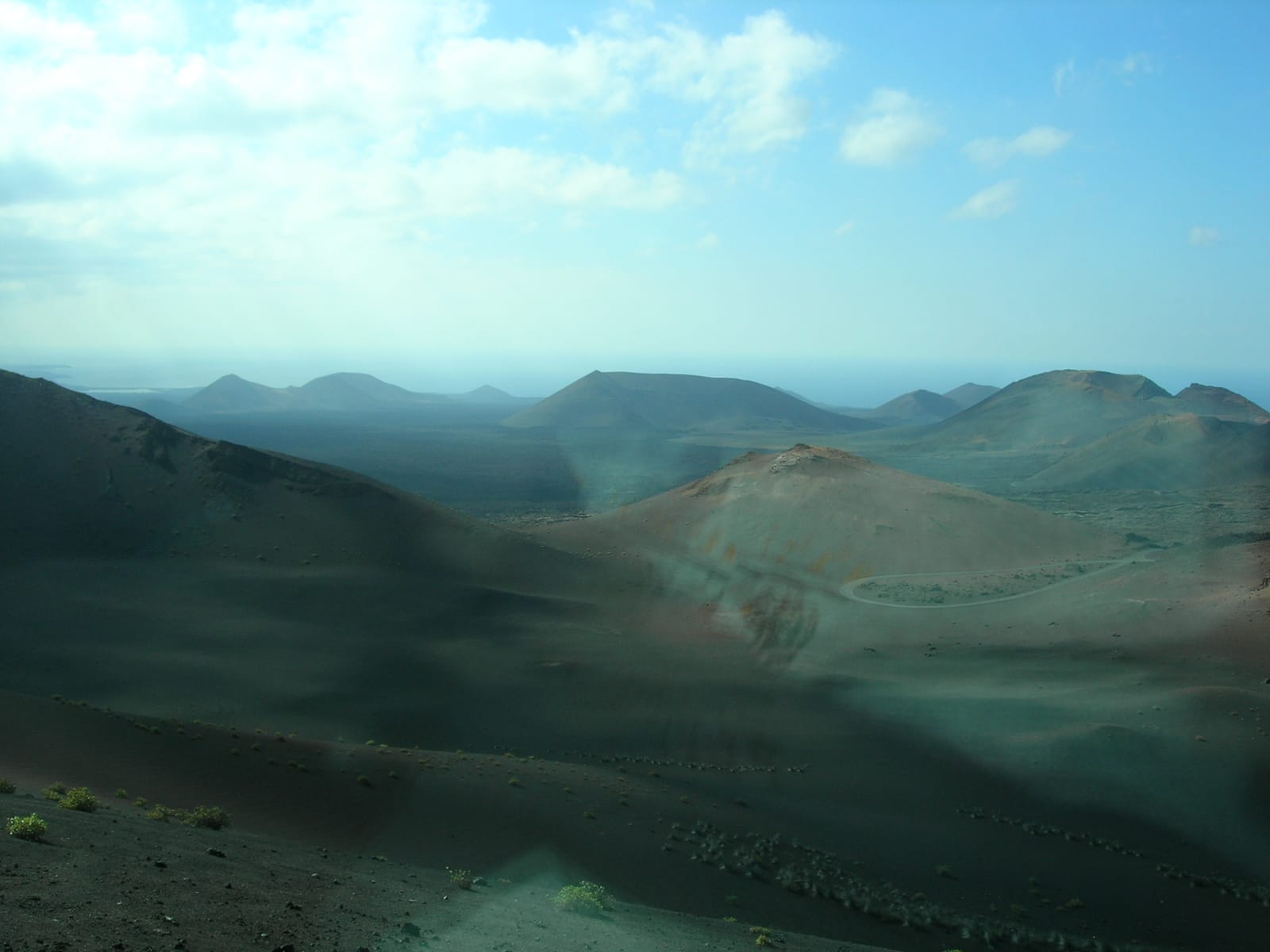 Ruta de los Volcanes through Timanfaya National Park in Lanzarote, dark volcanic cones rising from black lapilli plains