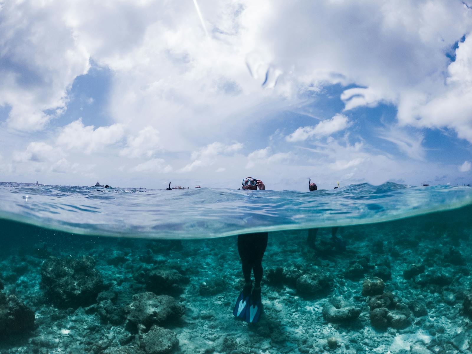 Snorkeler in mask floating in calm turquoise water, Costa Teguise, Lanzarote