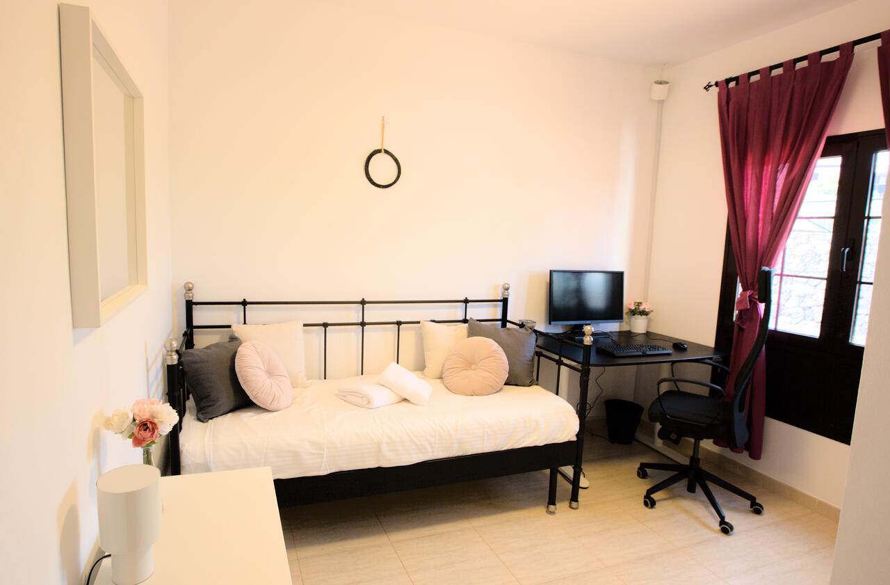 Studio bedroom at Casa Los Alisios with motorised sit-stand desk and Markus chair, Costa Teguise